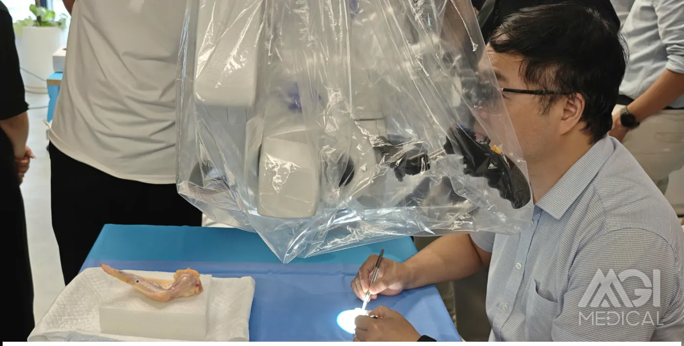 Practising anastomosis on a chicken wing under the operating microscope. Photo: MGI Medical.